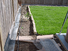 Wire mesh to seal gaps under fence.